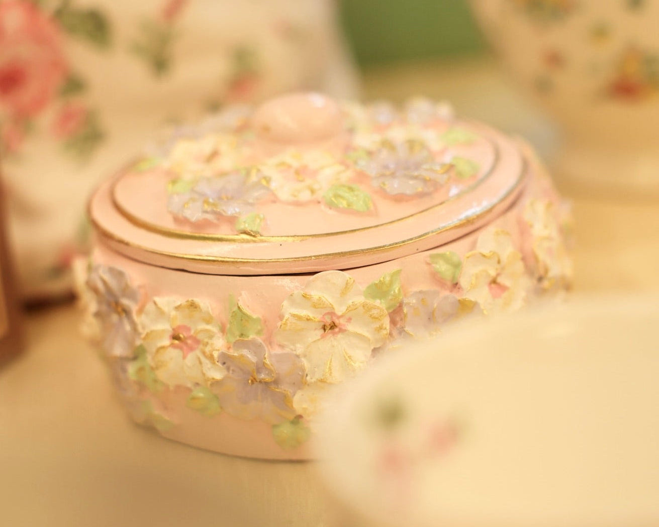 Decorative pink box with floral patterns on a blurred background