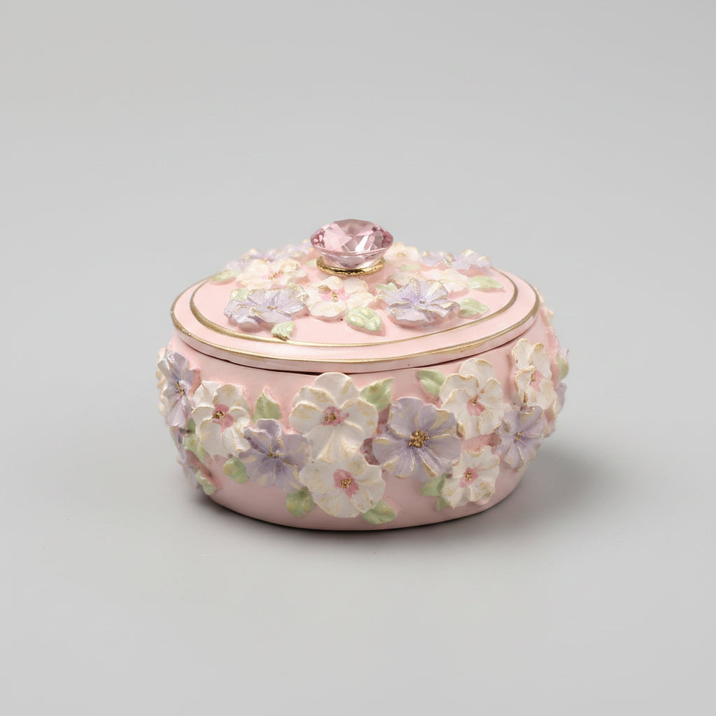 Decorative pink box with floral patterns on a blurred background